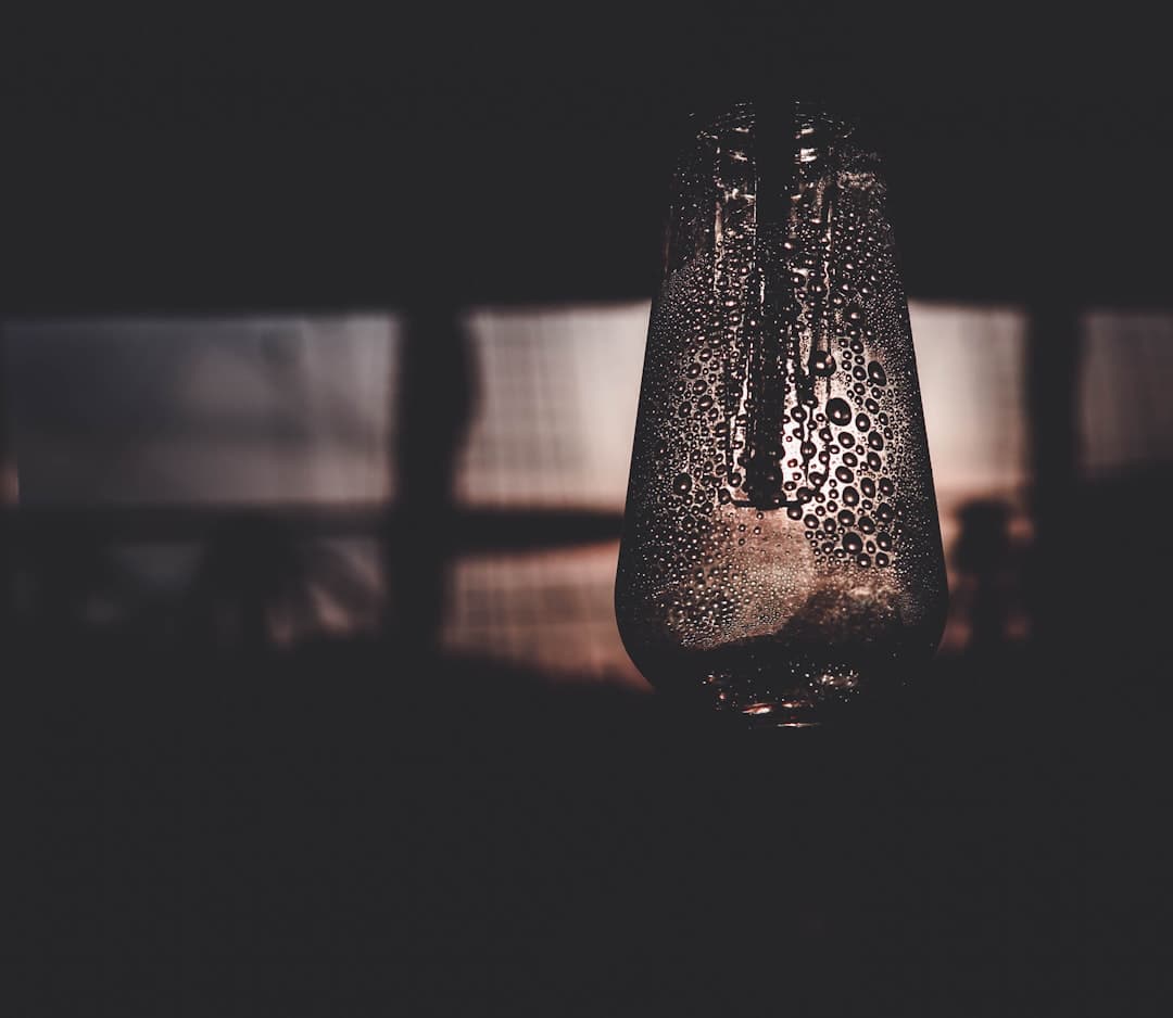 Red wine being poured in a dark moody setting