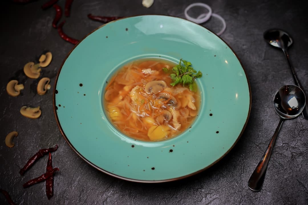 Seared scallops on a dark restaurant plate